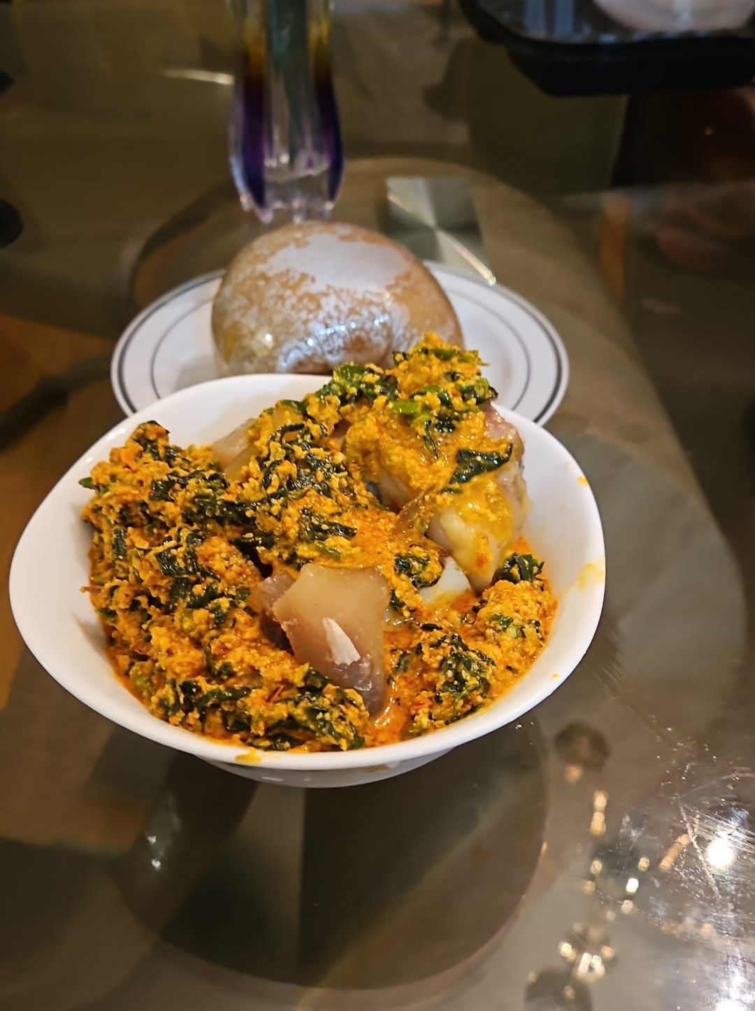 Egusi soup with beef, assorted meat, or goat meat with fufu $25.00